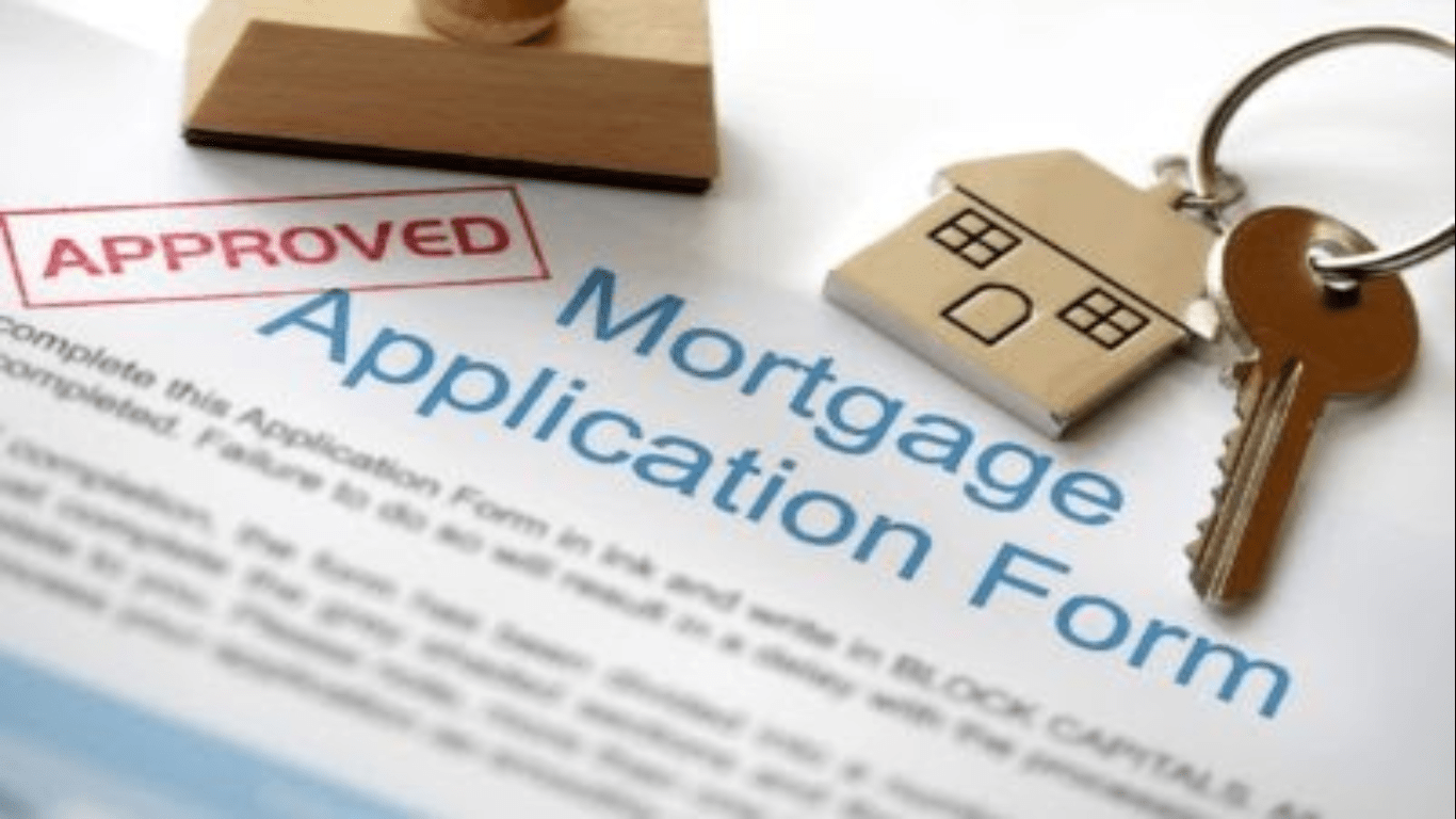 A mortgage application form with a stamp and wooden house.