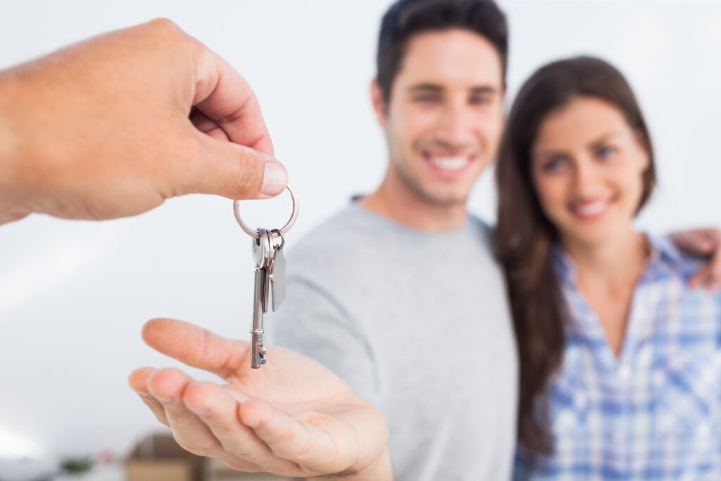Smiling couple getting their keys to their Home Sweet Home