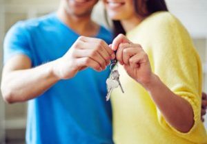 id theft buying a house couple holding a key